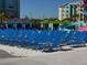 Spacious pool area featuring lounge chairs, colorful cabanas, and a water slide at 3151 Sunset Walk Dr # 314, Kissimmee, FL 34747