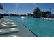 Zero-entry pool featuring in-water loungers and palm trees at 3151 Sunset Walk Dr # 314, Kissimmee, FL 34747