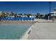 Relaxing pool area with blue lounge chairs, water slide, and colorful cabanas for a resort-style experience at 3151 Sunset Walk Dr # 314, Kissimmee, FL 34747