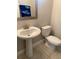 Bathroom featuring pedestal sink, toilet and decorative mirror at 168 Claffey Ct, Haines City, FL 33844
