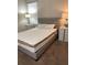Bedroom with a tufted headboard, white bedding, side tables, and a large window at 168 Claffey Ct, Haines City, FL 33844