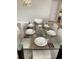 Close up view of dining room table, place settings and contemporary decor at 168 Claffey Ct, Haines City, FL 33844