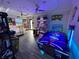 Spacious game room with air hockey, video games, and decorative touches, creating a fun and playful environment at 168 Claffey Ct, Haines City, FL 33844