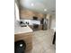 Bright kitchen with stainless steel appliances, subway tile backsplash and tile flooring at 168 Claffey Ct, Haines City, FL 33844