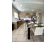 Bright kitchen with stainless steel appliances, plenty of cabinets and tile flooring at 168 Claffey Ct, Haines City, FL 33844