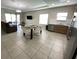 Open-concept living space featuring tile floors, modern furniture and access to outdoor space at 168 Claffey Ct, Haines City, FL 33844