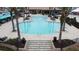 Community pool with palm trees and lounge chairs, creating a resort-style atmosphere at 168 Claffey Ct, Haines City, FL 33844