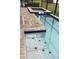 Pool area with a sun shelf and built-in hot tub, enclosed by a screen at 168 Claffey Ct, Haines City, FL 33844