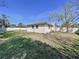 Large back yard bordered by a white privacy fence and manicured lawn at 1743 Wilshire Ct, Lakeland, FL 33813
