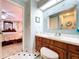 Bathroom featuring a white countertop and wooden vanity with access to bedroom at 1743 Wilshire Ct, Lakeland, FL 33813