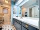 Bathroom features a large mirror, white counter, blue cabinets and decor at 1743 Wilshire Ct, Lakeland, FL 33813