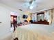 Bedroom featuring a desk, tv, and doorway to dining area at 1743 Wilshire Ct, Lakeland, FL 33813