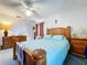 Bedroom featuring bed, two dressers, window with blinds, and ceiling fan at 1743 Wilshire Ct, Lakeland, FL 33813