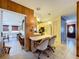 Open-concept dining area with vintage furniture and fixtures and hardwood paneling at 1743 Wilshire Ct, Lakeland, FL 33813