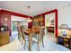 The dining room showcases wood table, chandelier, access to patio, and is adjacent to the living room at 1743 Wilshire Ct, Lakeland, FL 33813
