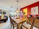 This dining room features a wood table, chandelier, and is adjacent to the living room and kitchen at 1743 Wilshire Ct, Lakeland, FL 33813