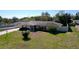 Well-kept, single-story home with beautiful landscaping, a brick facade, and a neatly manicured lawn at 1743 Wilshire Ct, Lakeland, FL 33813