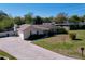 Well maintained single story home with a large driveway and mature landscaping at 1743 Wilshire Ct, Lakeland, FL 33813