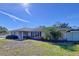 Charming single-story home with a brick facade, well-maintained lawn, and mature landscaping at 1743 Wilshire Ct, Lakeland, FL 33813