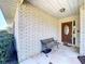 Charming entryway with brick facade, stone walkway, and a rustic wooden bench providing a warm welcome at 1743 Wilshire Ct, Lakeland, FL 33813
