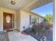 Inviting front porch features stone walkway, brick facade, and a stylish wooden door with beautiful landscaping at 1743 Wilshire Ct, Lakeland, FL 33813