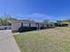 Traditional ranch style home with brick and a well manicured front lawn and foliage at 1743 Wilshire Ct, Lakeland, FL 33813