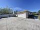 Attached two car garage with an expansive cracked concrete driveway at 1743 Wilshire Ct, Lakeland, FL 33813