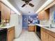 Spacious kitchen with wood cabinets and stainless steel appliances and view into the living room at 1743 Wilshire Ct, Lakeland, FL 33813