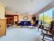 Bright and airy living area with large windows, comfortable seating, and an open layout into the adjacent dining area at 1743 Wilshire Ct, Lakeland, FL 33813