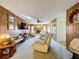 Spacious living room featuring a brick fireplace, ceiling fan, and wood paneled walls at 1743 Wilshire Ct, Lakeland, FL 33813
