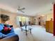 Spacious living area with plush carpeting, ceiling fans, and large windows offering plenty of natural light at 1743 Wilshire Ct, Lakeland, FL 33813