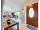 Inviting living room features a tiled entryway with hardwood door and a comfortable seating area with ample natural light at 1743 Wilshire Ct, Lakeland, FL 33813