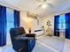 Comfortable living room with blue curtains, a ceiling fan and a relaxing recliner at 1743 Wilshire Ct, Lakeland, FL 33813