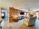 Comfortable living room with wood paneling and a brick fireplace for cozy living at 1743 Wilshire Ct, Lakeland, FL 33813
