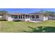 Back of the house featuring a patio with stone surface and screened-in porch at 1743 Wilshire Ct, Lakeland, FL 33813
