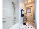 The white tiled shower has safety bars and handheld shower head at 1743 Wilshire Ct, Lakeland, FL 33813