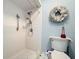 The walk-in shower features white tile, grab bars, and a handheld shower head at 1743 Wilshire Ct, Lakeland, FL 33813