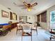 Cozy sunroom has neutral tile flooring, ceiling fan, and sliding door access to yard at 1743 Wilshire Ct, Lakeland, FL 33813