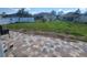 Back yard with brick patio and green grass at 661 Crane Dr, Kissimmee, FL 34759
