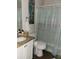Bathroom featuring a granite-style countertop, sink, toilet, and a shower with a colorful curtain at 661 Crane Dr, Kissimmee, FL 34759