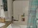 Bright bathroom featuring updated shower, tile floors, granite countertop and modern fixtures at 661 Crane Dr, Kissimmee, FL 34759