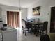 Comfortable dining area with tile flooring, lighting fixture, and access to the backyard at 661 Crane Dr, Kissimmee, FL 34759