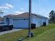 One story home with a two-car garage and solar panels at 661 Crane Dr, Kissimmee, FL 34759