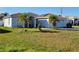 Charming home featuring a well-maintained lawn and mature palm trees, with solar panels discreetly installed at 661 Crane Dr, Kissimmee, FL 34759