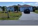 Charming single-story home featuring a two-car garage and drought-resistant landscaping at 661 Crane Dr, Kissimmee, FL 34759