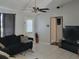 Relaxing living room with tile flooring, ceiling fan, and sliding glass door for natural light at 661 Crane Dr, Kissimmee, FL 34759