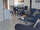 Open-concept living room featuring tile flooring and comfortable furniture at 661 Crane Dr, Kissimmee, FL 34759