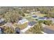 Aerial view of a single-story home with a dark gray roof, long driveway, and mature trees at 420 Tecumseh N Ave, Fort Meade, FL 33841