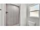 A well-lit bathroom featuring a tiled shower and modern fixtures at 420 Tecumseh N Ave, Fort Meade, FL 33841