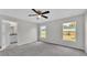 Bedroom with carpet and ample natural light with an attached bathroom at 420 Tecumseh N Ave, Fort Meade, FL 33841